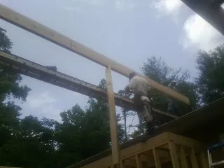 Carpenter setting a ridge beam over a new addition frame — Ice Dam Removal by Roofing Brothers in Twin Falls